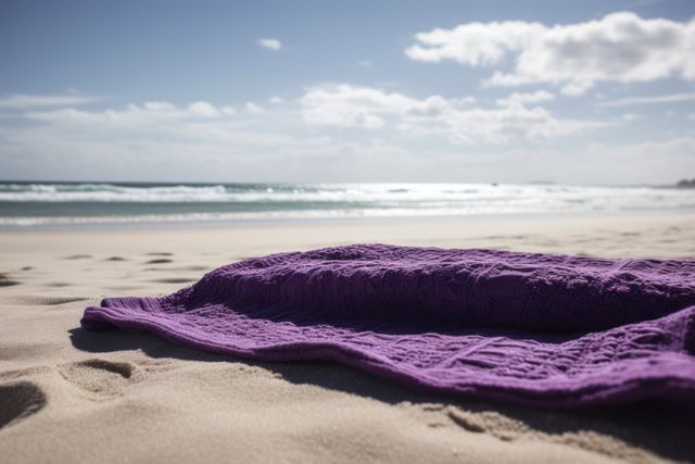 Purple towel with pattern on beach with sea and blue sky, created using generative ai technology. Seaside landscape, vacation, leisure, summer and nature concept digitally generated image.