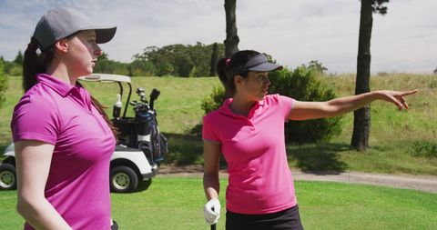 Two Female Golfers Standing on Golf Course - Download Free Stock Images Pikwizard.com