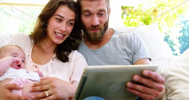 Couple with children looking at tablet computer outside - Download Free Stock Photos Pikwizard.com