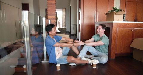 Couple Relaxing at Home with Coffee Holding Hands