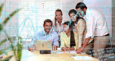 Business team analyzing stock market charts together in collaborative office meeting
