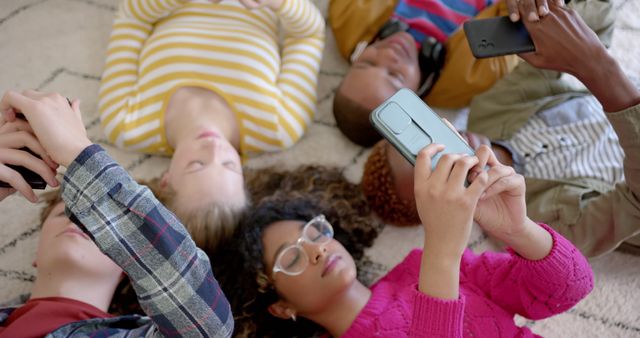 Diverse Group of Friends Lying on Floor and Using Smartphones - Download Free Stock Images Pikwizard.com