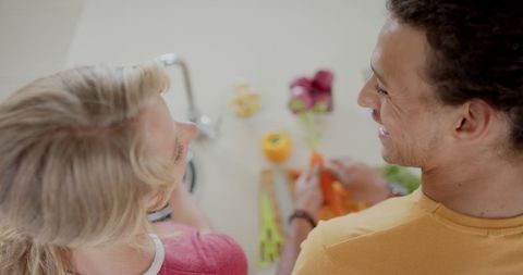 Diverse Couple Joyfully Cooking Together in Kitchen