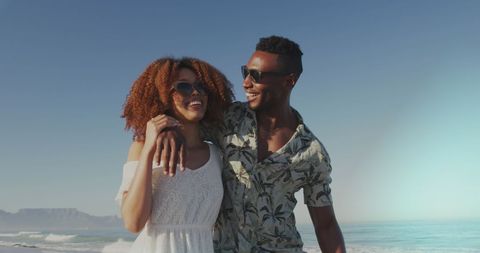 Joyful African American Couple Strolling on Sunny Beach