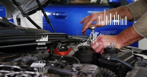 Mechanic tightening engine bolt with wrench with digital diagnostics and graphs overlay