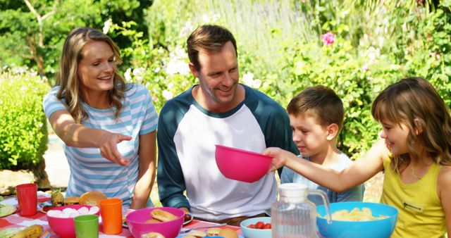 Happy Family Enjoying Outdoor Picnic in Summer Garden - Download Free Stock Images Pikwizard.com