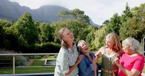 Joyful Seniors Laughing Together in Scenic Outdoors