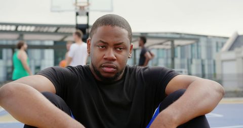 Thoughtful Young Athlete Resting on Basketball Court - Download Free Stock Images Pikwizard.com