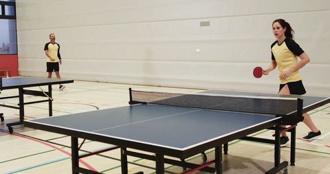 Dynamic Mixed Doubles Table Tennis Match in Gym