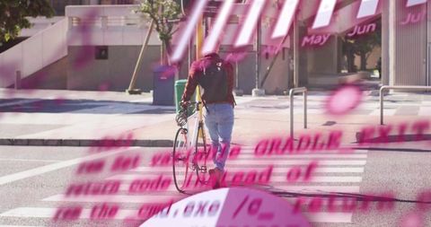 Commuter pushing road bike across crosswalk in maroon jacket and backpack with pink blur