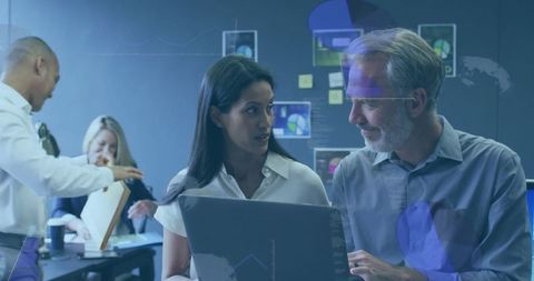 Business team collaborating with technology in meeting room