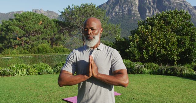 African american senior man practicing yoga and meditating in the garden - Download Free Stock Photos Pikwizard.com