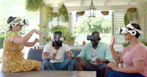 Friends Enjoying Virtual Reality Headsets in Bright Sunroom for Social Gaming