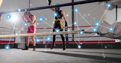 Female boxers sparring in gym ring with digital data overlay showing performance metrics
