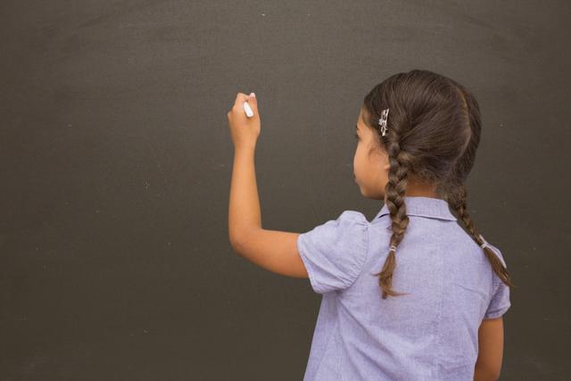 Digital composite of School girl writing on blackboard