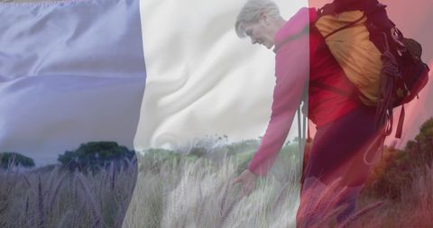 Joyful Hiker Overlaid with French Flag in Idyllic Field