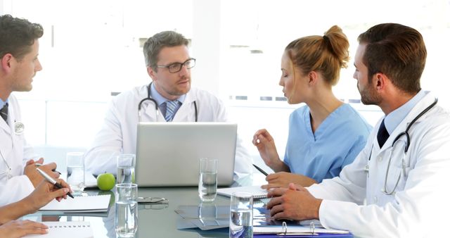 Medical Team in Discussion Around Table in Modern Hospital Setting - Download Free Stock Images Pikwizard.com