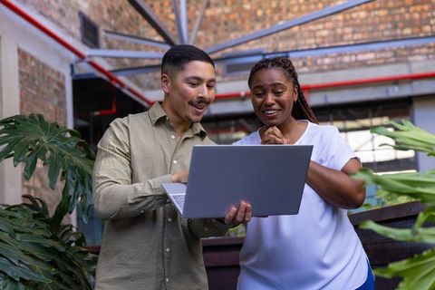 Diverse Team Engaging in Creative Collaboration with Laptop
