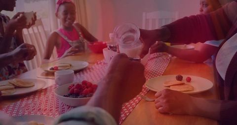 Family Sharing Breakfast with Pancakes and Fresh Berries