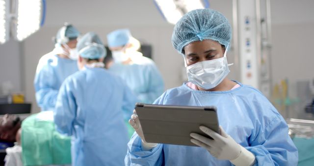 African American Female Doctor Using Digital Tablet in Operating Room - Download Free Stock Images Pikwizard.com