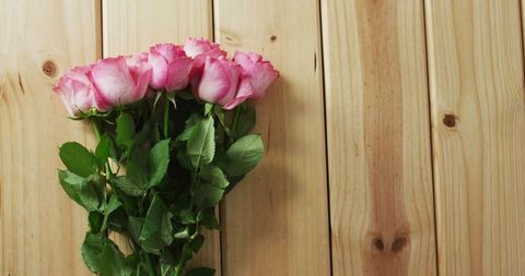 Elegant Pink Roses Bouquet on Rustic Wooden Surface