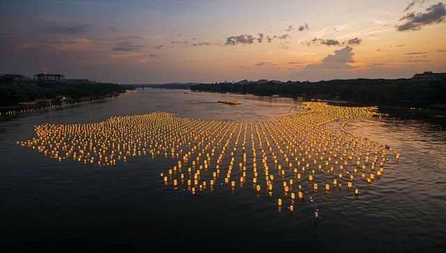 River of Floating Lanterns Illuminating Dusk Tranquility