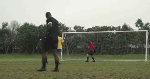 Soccer Goalkeeper Preparing to Block Incoming Shot During Game