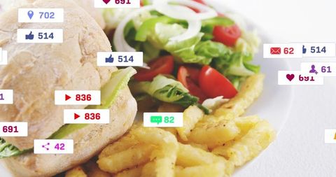 Close-up showing sandwich, crinkle fries and fresh salad on white plate with social badges