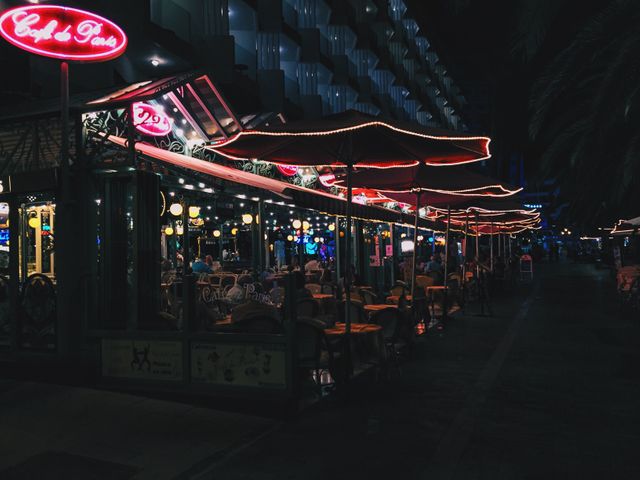 Cozy Outdoor Cafe with Red Neon Lights at Night - Download Free Stock Photos Pikwizard.com