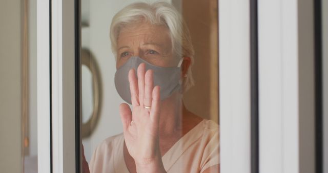 Senior Woman in Mask Looking Through Window During Quarantine - Download Free Stock Images Pikwizard.com