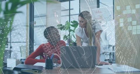 Female Coworkers Collaborating at Open-Plan Desk with Laptop and Project Planning Overlay
