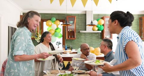 Senior friends celebrating with lively dinner party gathering