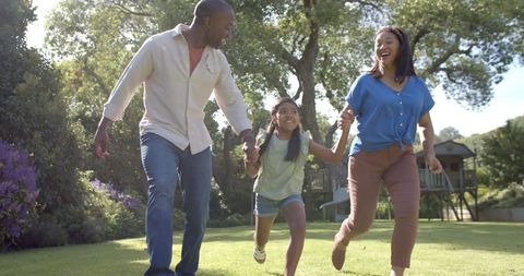 Happy Family Bonding Time Outdoors in a Lush Park