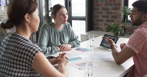 Creative Team Discussing Mobile App Design in Modern Office