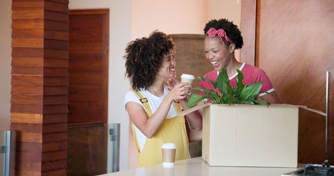 Joyful Unpacking at Home with Smiling Women