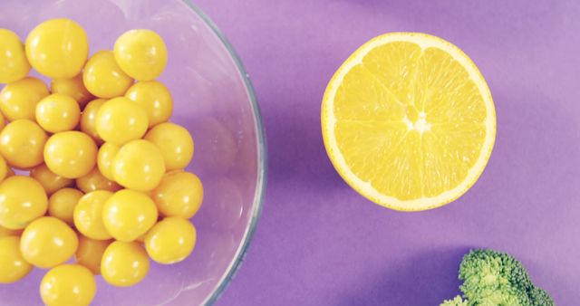 Fresh Oranges and Yellow Tomatoes on Purple Background - Download Free Stock Images Pikwizard.com
