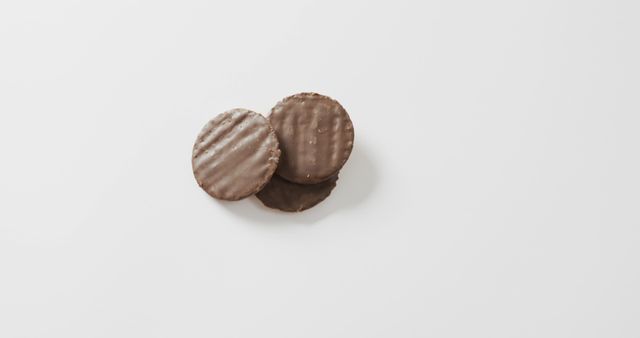Delicious chocolate covered biscuits placed on a white background, focusing attention on the treats. Perfect for use in food blogs, dessert recipe pictures, snack promotions, or editorial pieces about sweets. This image can also be used in menus, advertisements, or packaging design for bakery products.