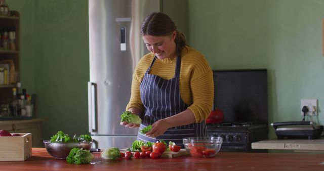 Woman Wearing Apron Preparing Fresh Vegetables in Kitchen - Download Free Stock Images Pikwizard.com