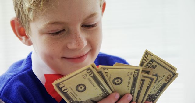 Happy Boy Counting Money With Excitement - Download Free Stock Images Pikwizard.com