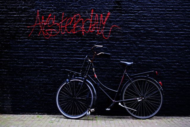 Vintage Bicycle Against Graffiti Wall in Amsterdam - Download Free Stock Photos Pikwizard.com