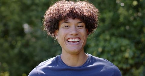 Young African American Man Smiling Outdoors in Navy T-Shirt