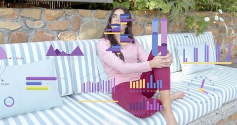 Sitting woman in pink top and red pants on striped patio bench with colorful data overlays