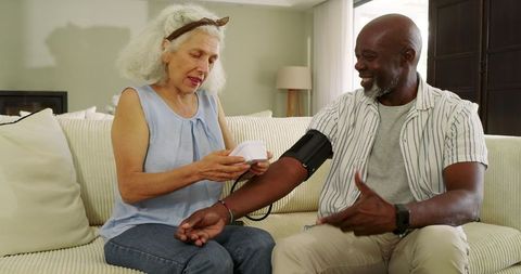 Senior Couple Checking Blood Pressure at Home for Well-Being