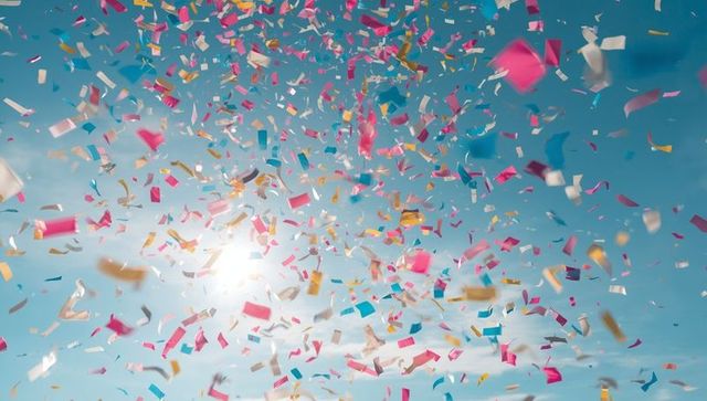Colorful Confetti Scattering Across Blue Sky Celebrating