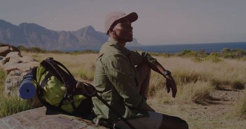 Hiker Enjoying Mountain and Ocean Views on Coastal Ledge