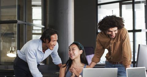 Diverse Colleagues Collaborate Happily in Modern Office Setting