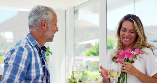 Senior Couple Enjoying Romantic Lunch with Flowers and Wine - Download Free Stock Images Pikwizard.com