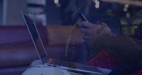 Professional Man Using Smartphone and Laptop with Digital Data Overlay