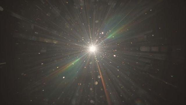 Radiant light burst with lens flare and dust particles
