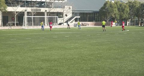 School Team Soccer Practice on Green Field